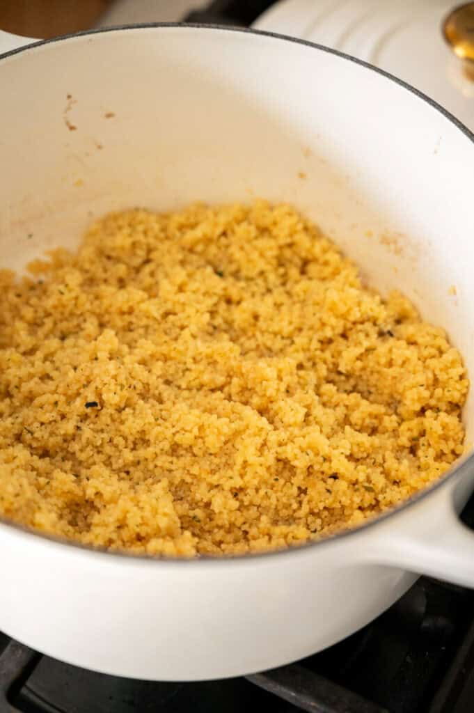 cooked fluffy couscous in a pot.