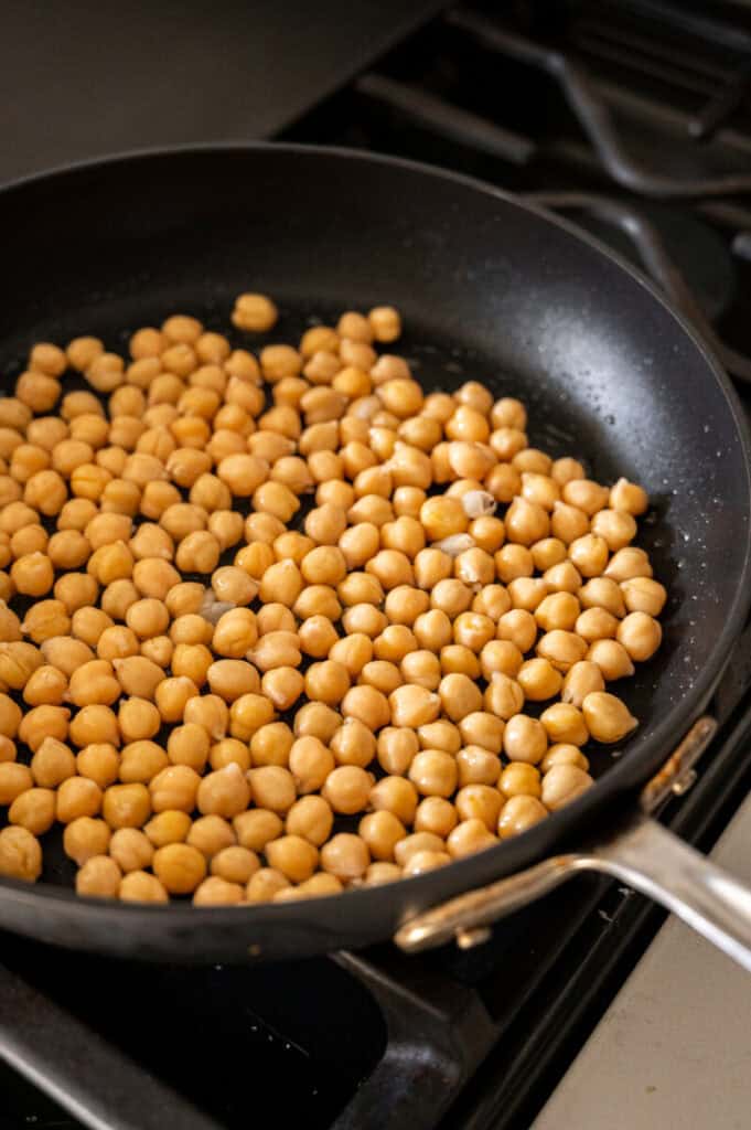 chickpeas toasting in a pan.