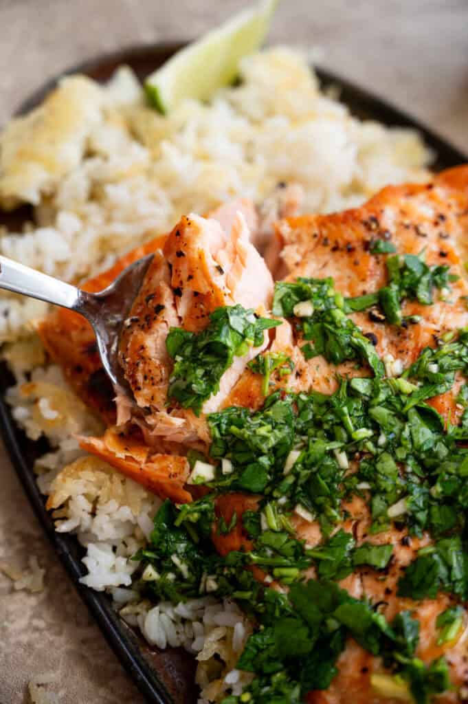 close up shot of roasted salmon with salsa verde.