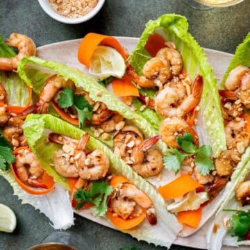 Shrimp lettuce wraps with peanuts and carrots.