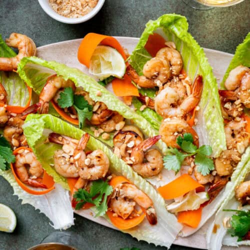 Shrimp lettuce wraps with peanuts and carrots.
