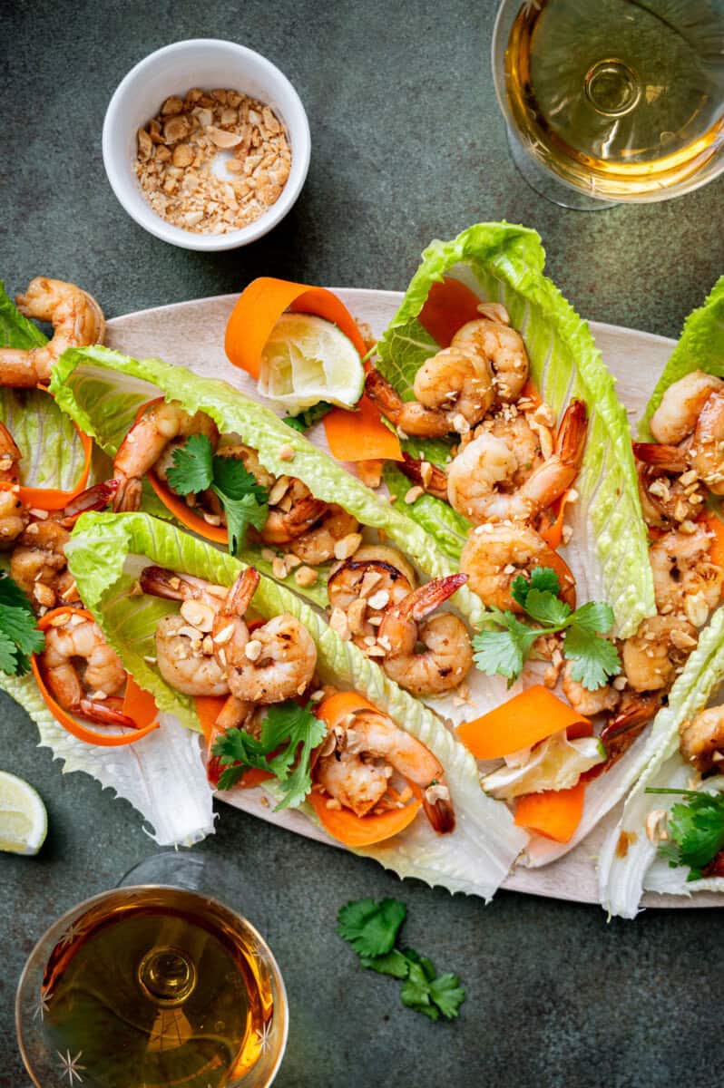 Shrimp lettuce wraps with peanuts and carrots.