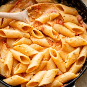 tomato and garlic penne in a pan.