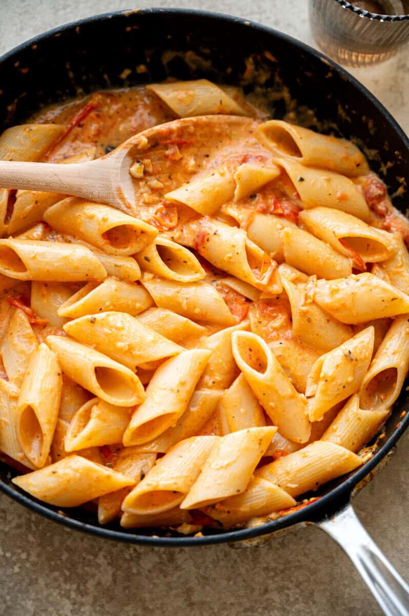 tomato and garlic penne in a pan.