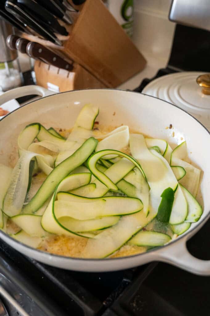 zucchini cooking in a pan.