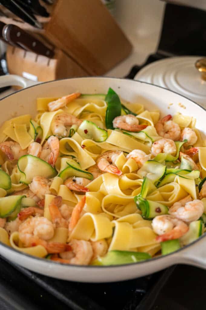 pasta with shrimp and zucchini in a skillet.