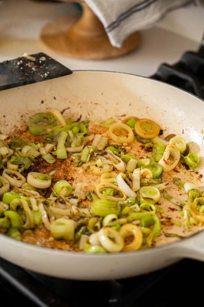 sautéed leeks in a skillet.