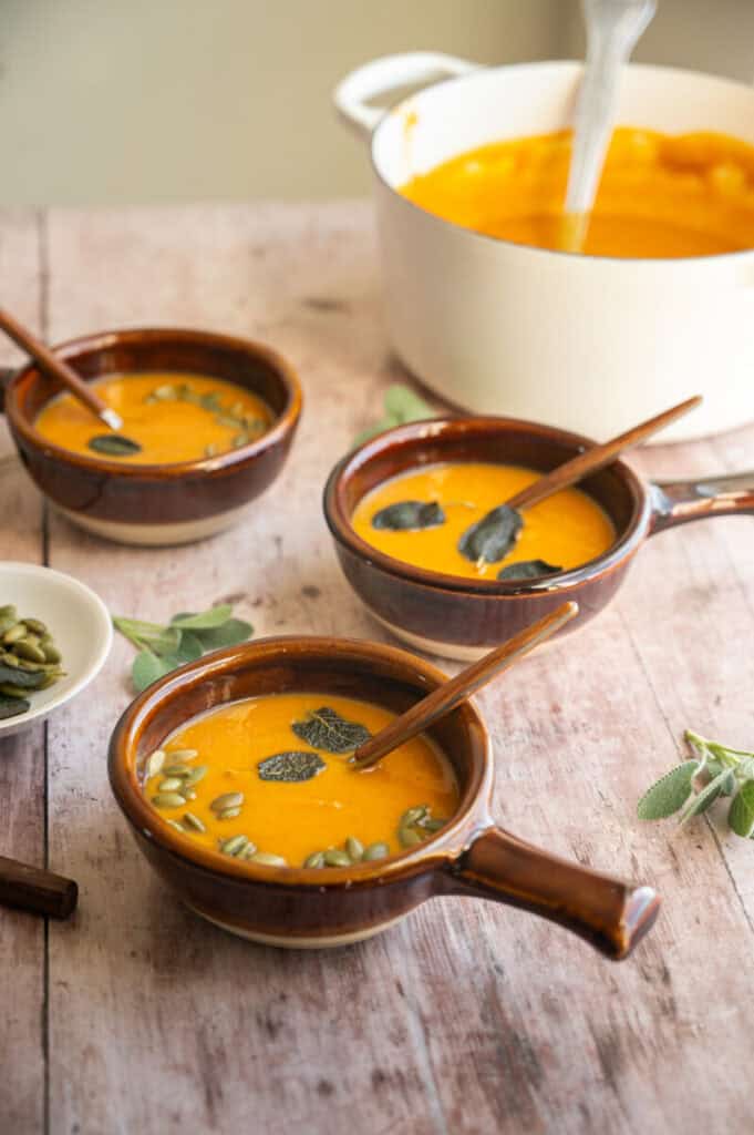 carrot and butternut squash soup in bowls.