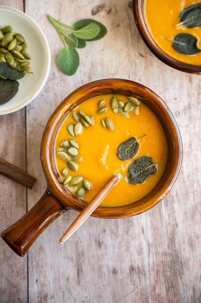 close up shot of carrot and butternut squash soup.