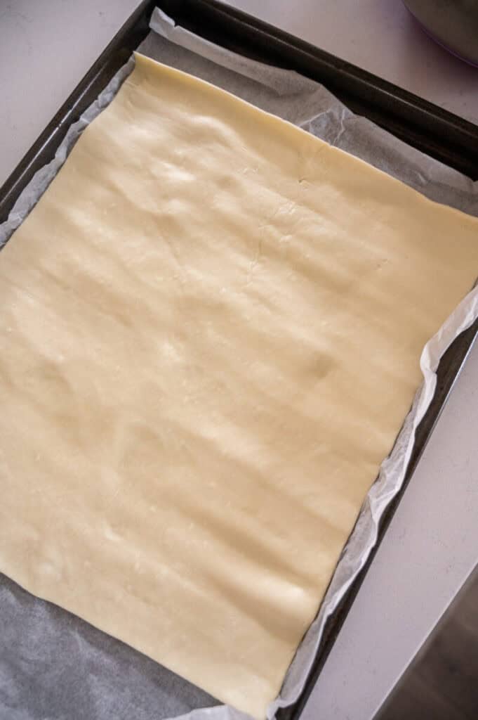 puff pastry rolled on a baking tray.