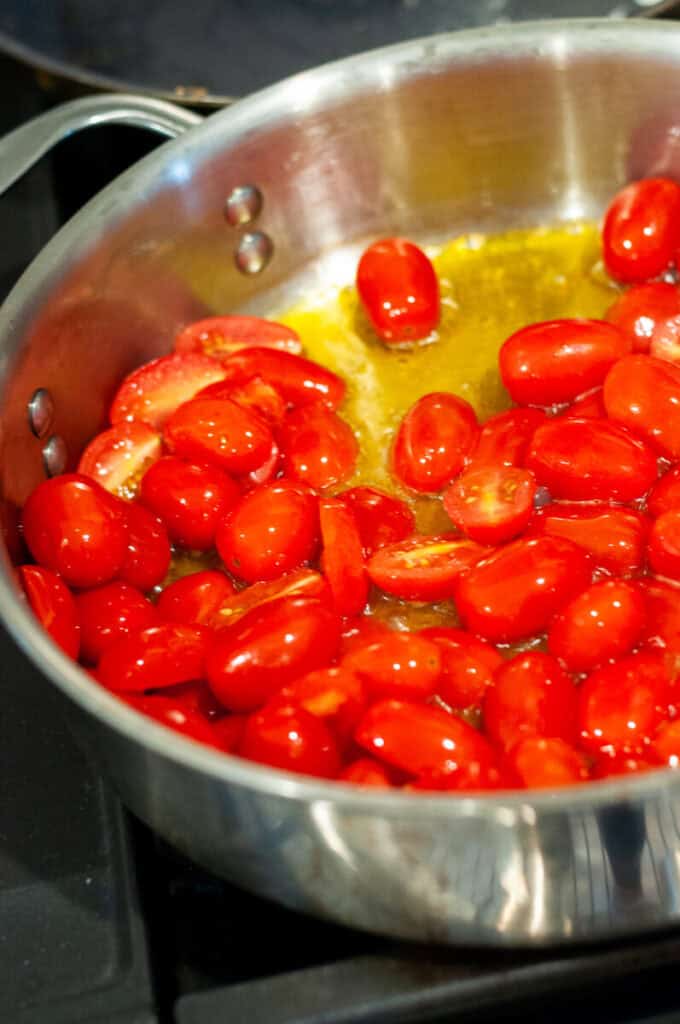 tomatoes cooking in a pan.