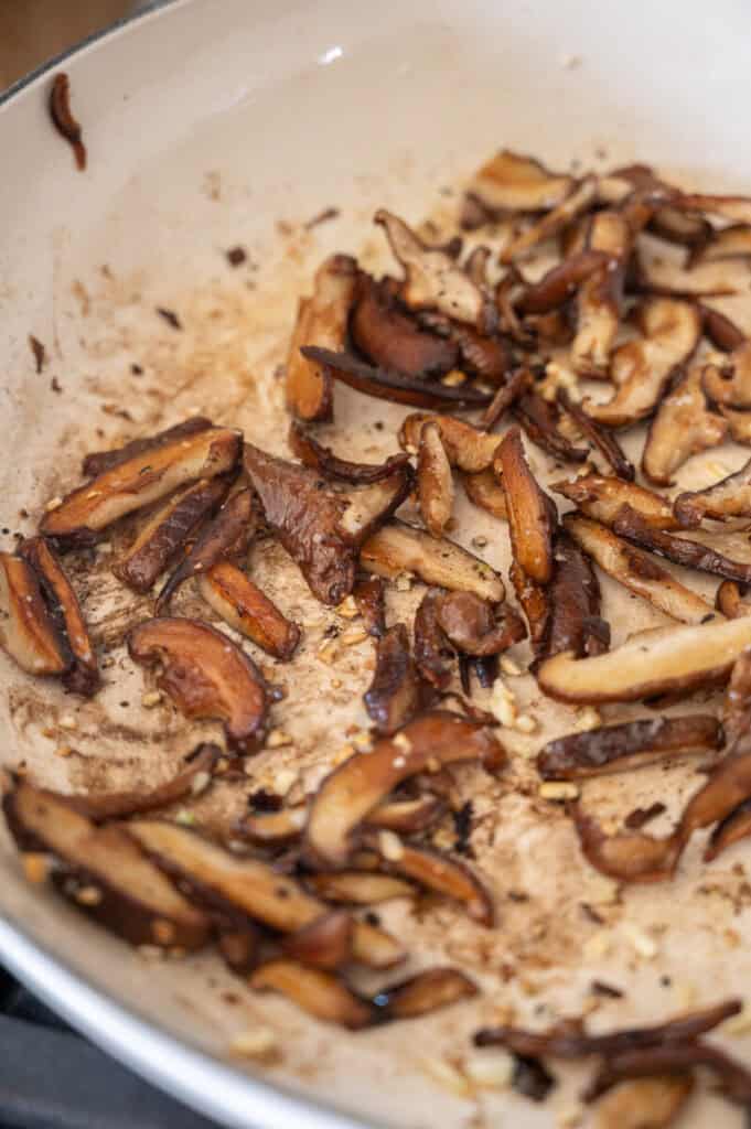 mushrooms browning in a pan.