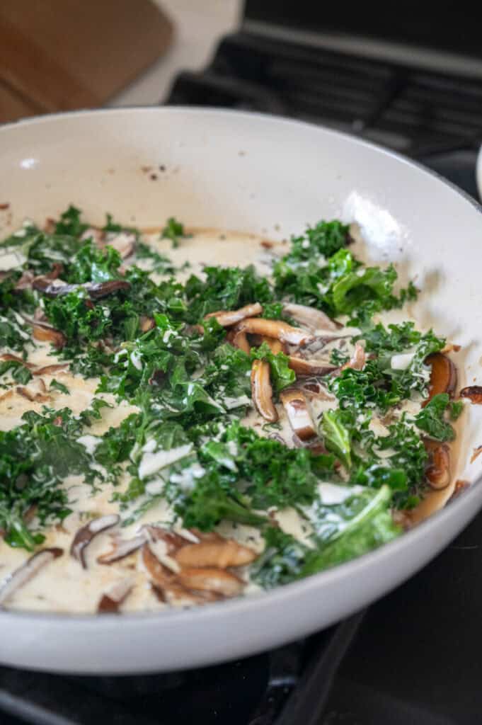kale and mushrooms in a creamy sauce.