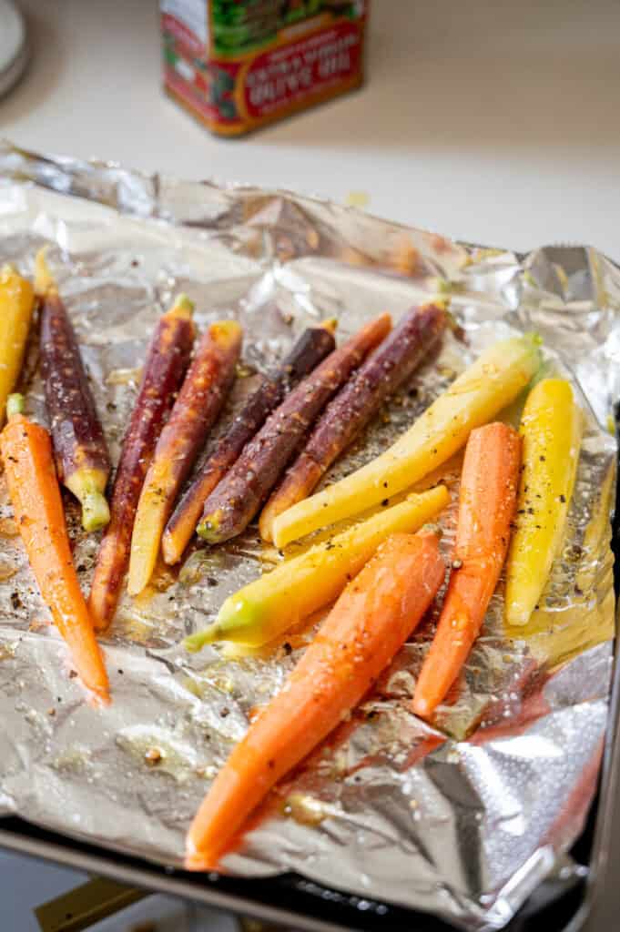 carrots on a baking sheet with olive oil, salt, and pepper.