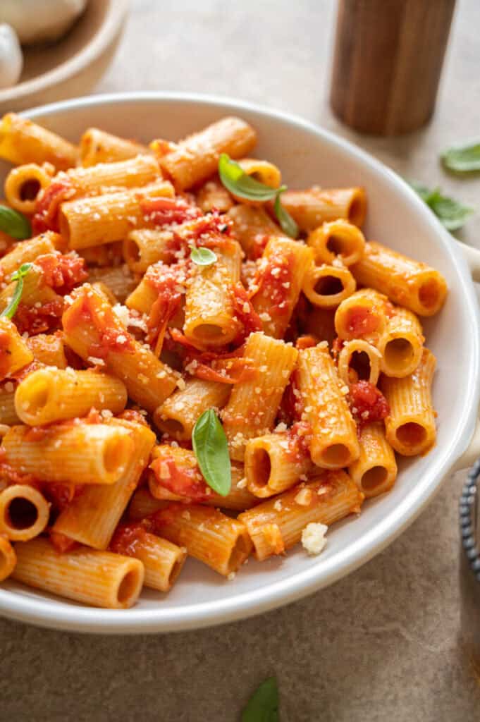 bruschetta pasta in a bowl with fresh basil.