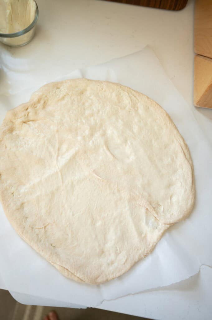 pizza dough on parchment paper.