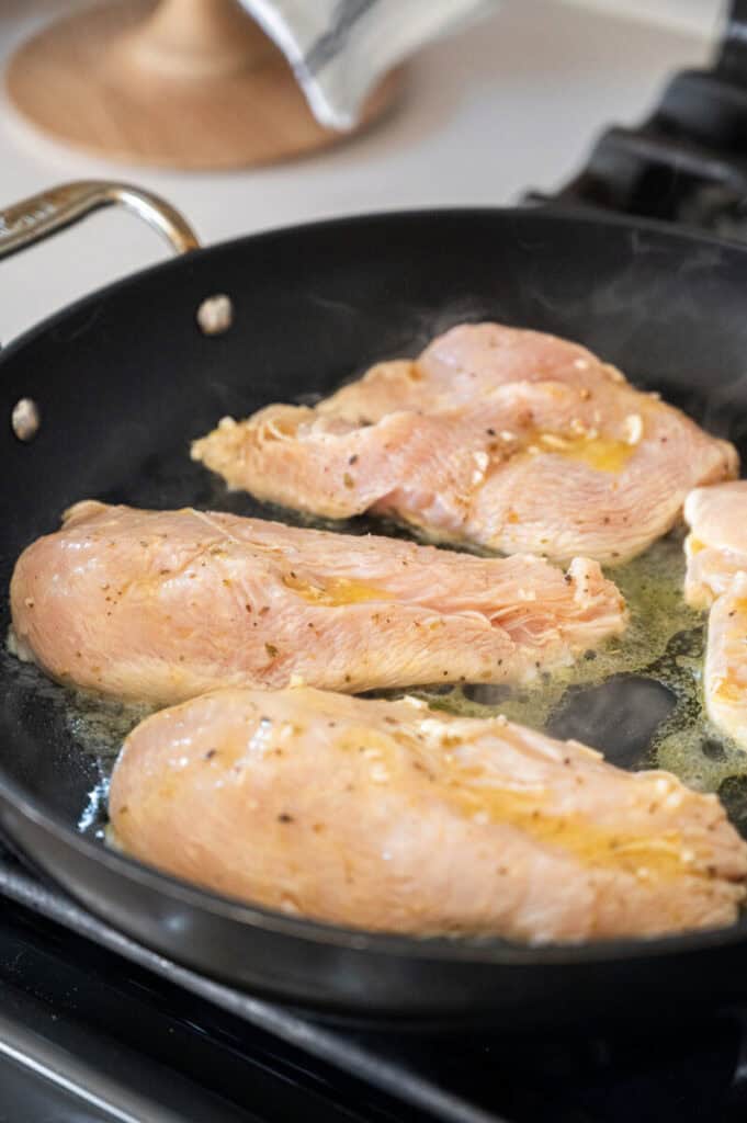 chicken cooking in a pan.