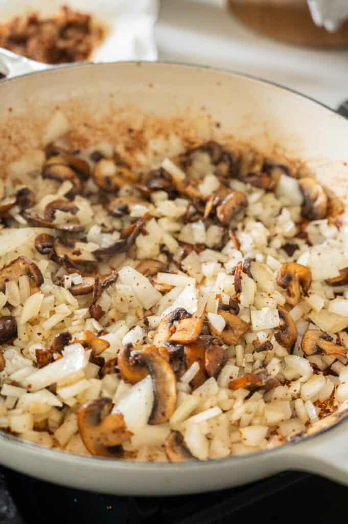 mushrooms and onions in a skillet.