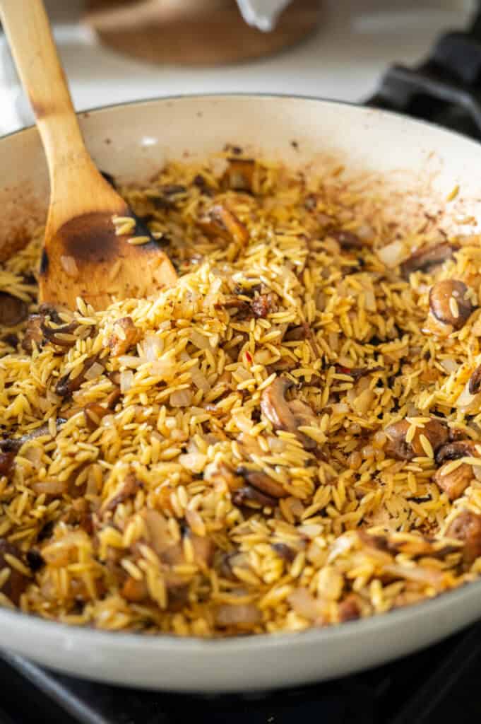 Orzo in a skillet.