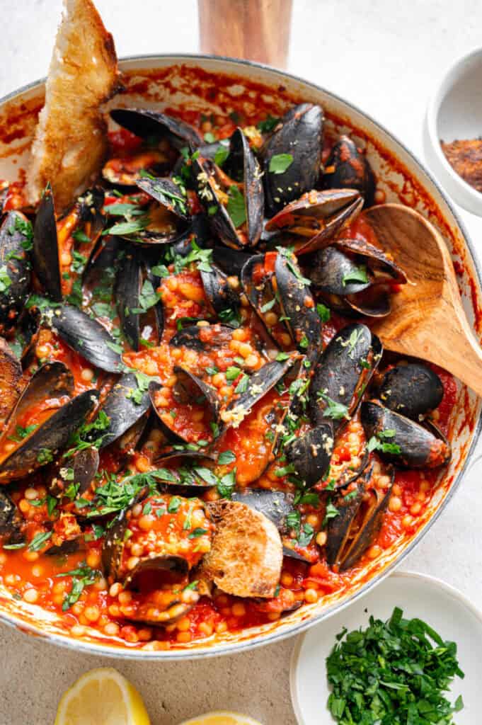 mussels with couscous in a tomato broth.