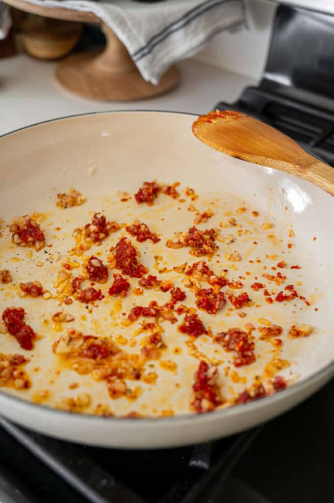shallot and tomato paste in a skillet.