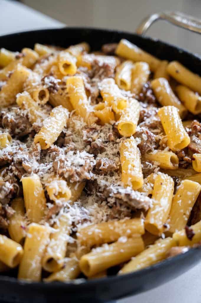 sausage and mushroom rigatoni in a skillet.