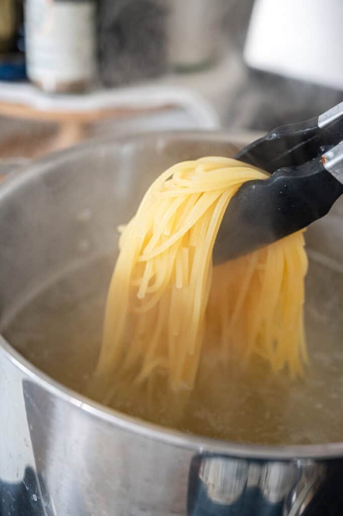 spaghetti cooking in a pot.