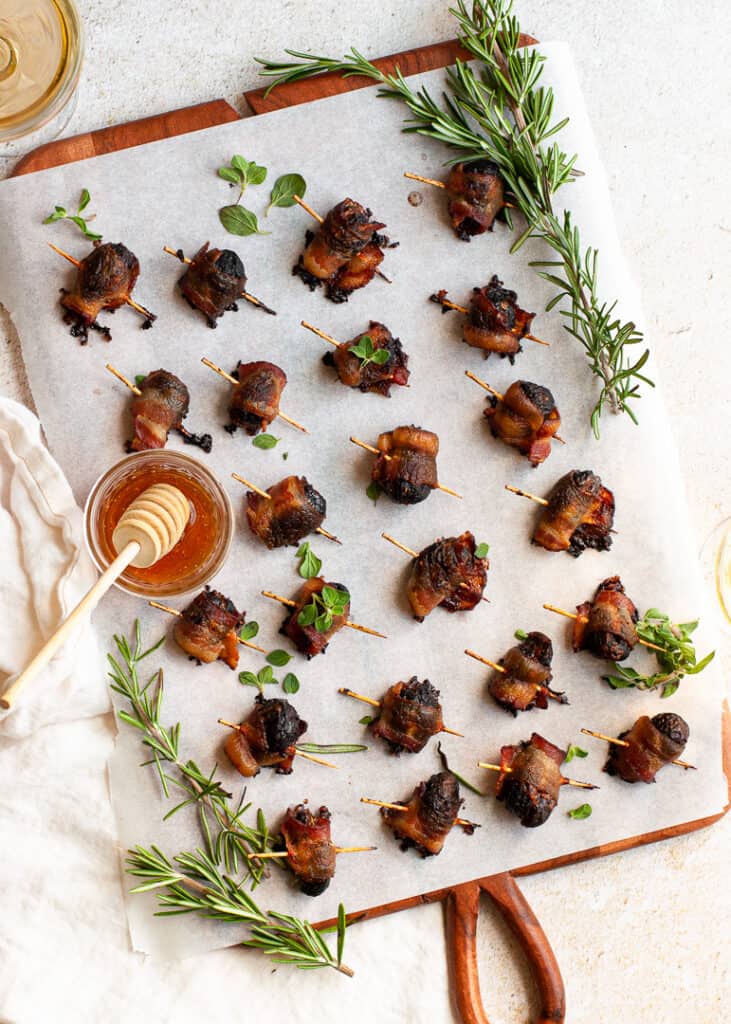 Bacon Wrapped Figs on a board with honey
