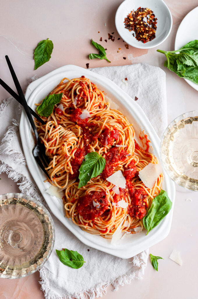 Spaghetti Arrabiata on a platter with forks
