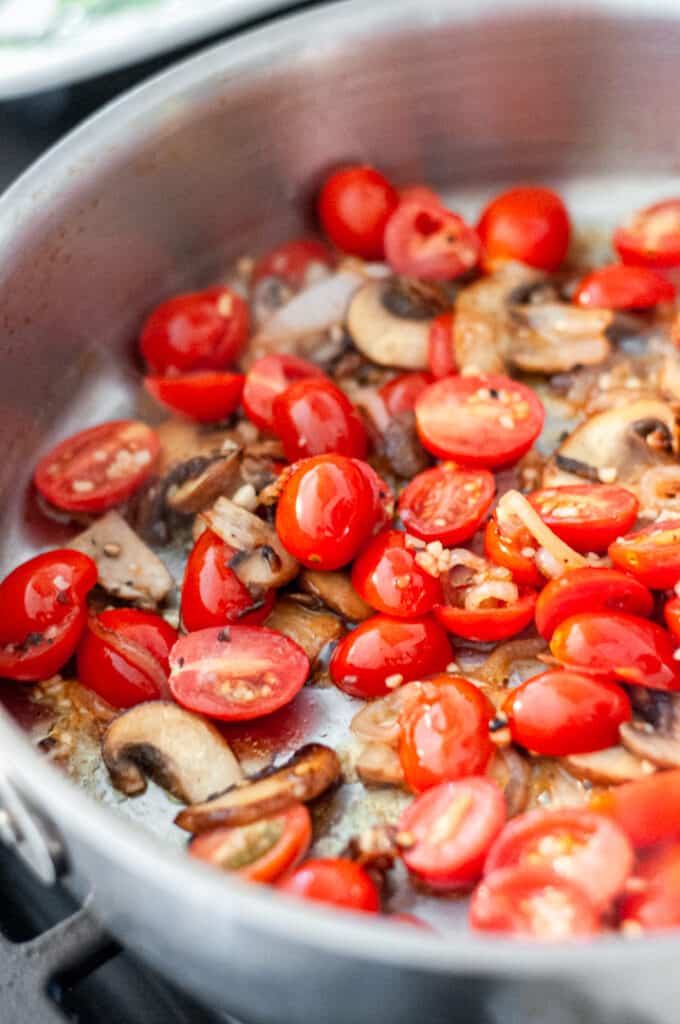 tomatoes and mushrooms in a pan