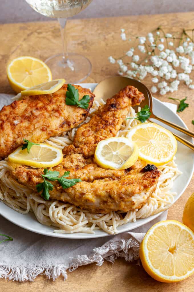 chicken limone and pasta on a plate