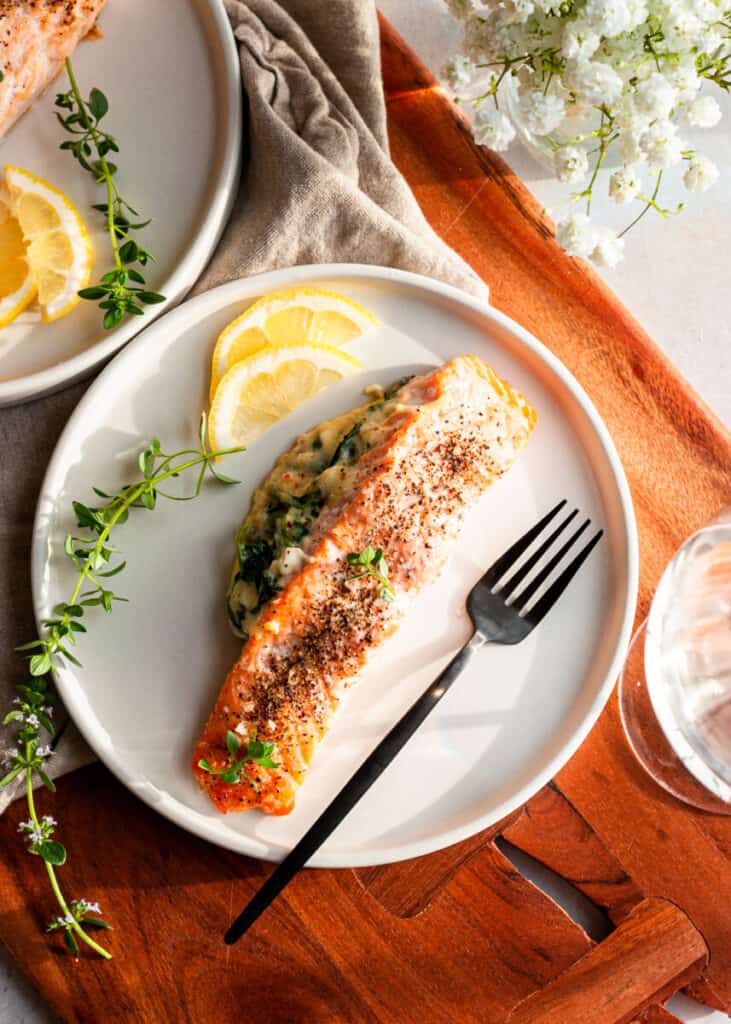 salmon on a plate with lemons and herbs