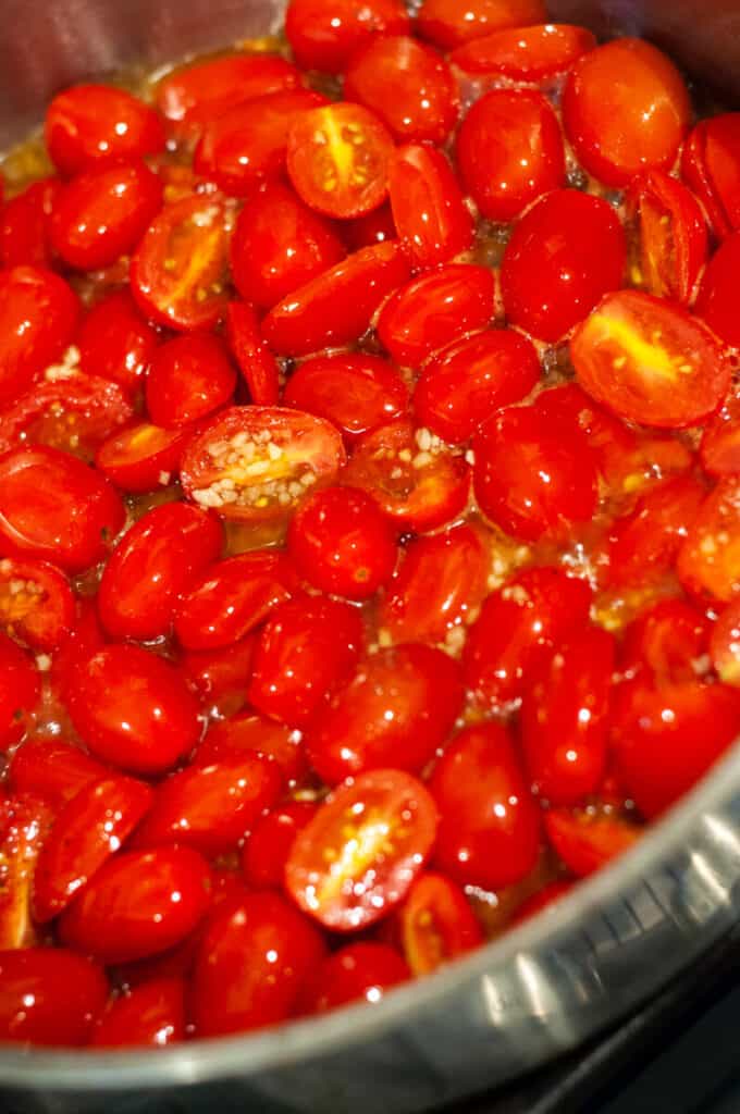 tomatoes and garlic cooking in a pan
