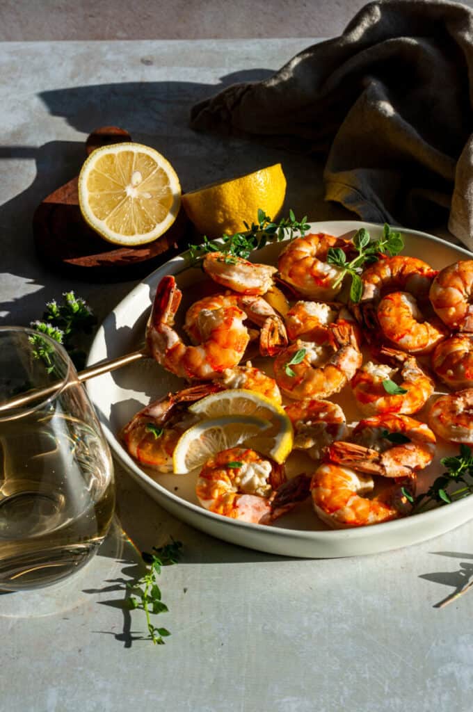 Shrimp on a plate with herbs and lemon