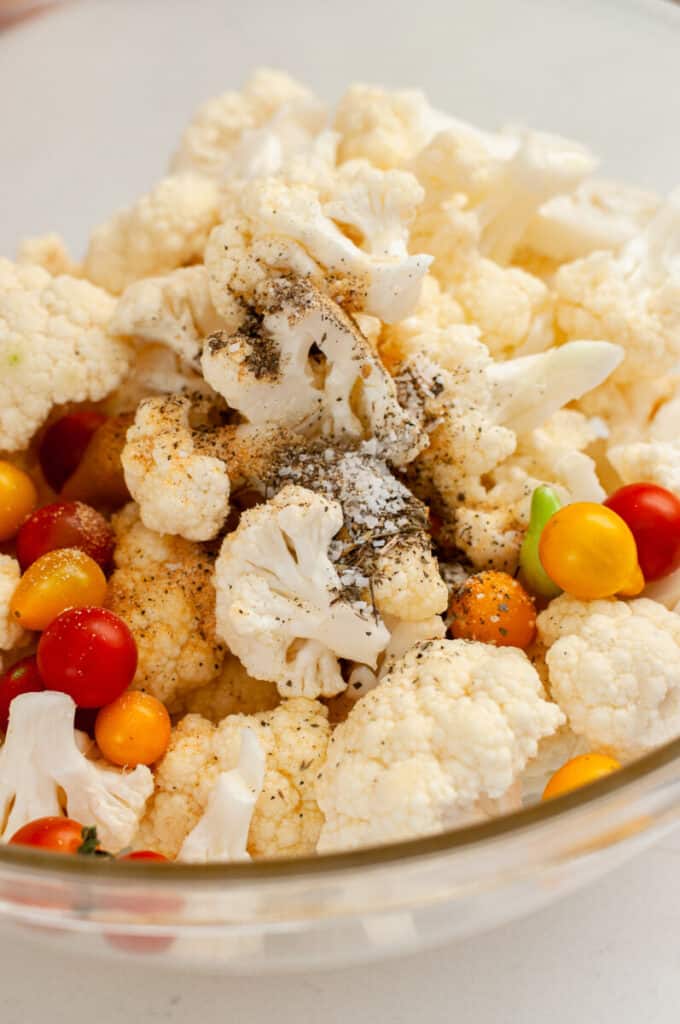 cauliflower, spices, and tomatoes in a bowl