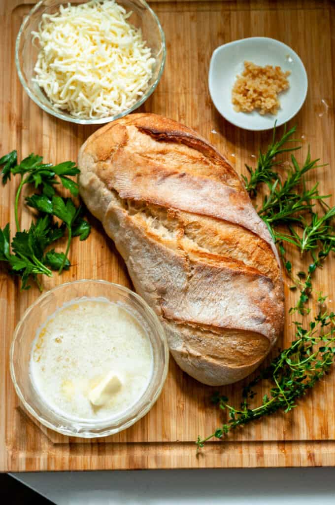 bread and herbs on a cutting board