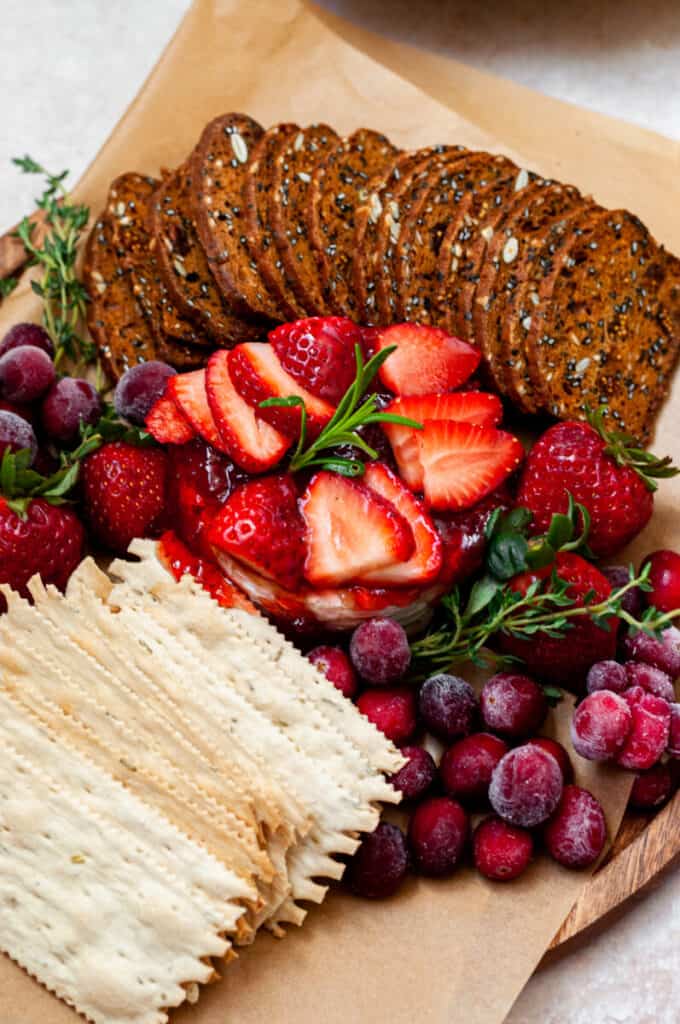 brie with crackers, strawberries, and cranberries