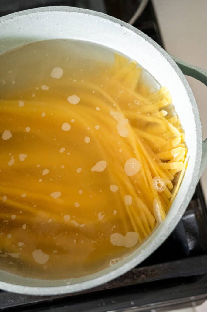 fettuccine cooking in a pot.