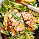 grilled salmon salad on a black platter