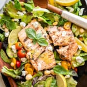 grilled salmon salad on a black platter