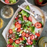 Strawberry Goat Cheese Salad on a plate with salad dressing