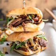 stacked steak sandwiches on ciabatta rolls