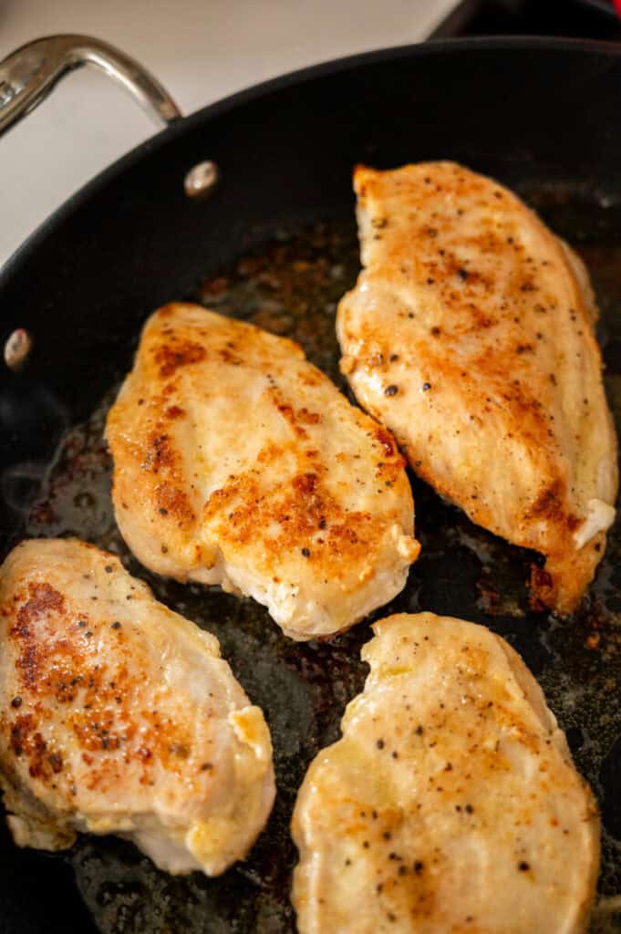 Chicken cooking in a skillet.