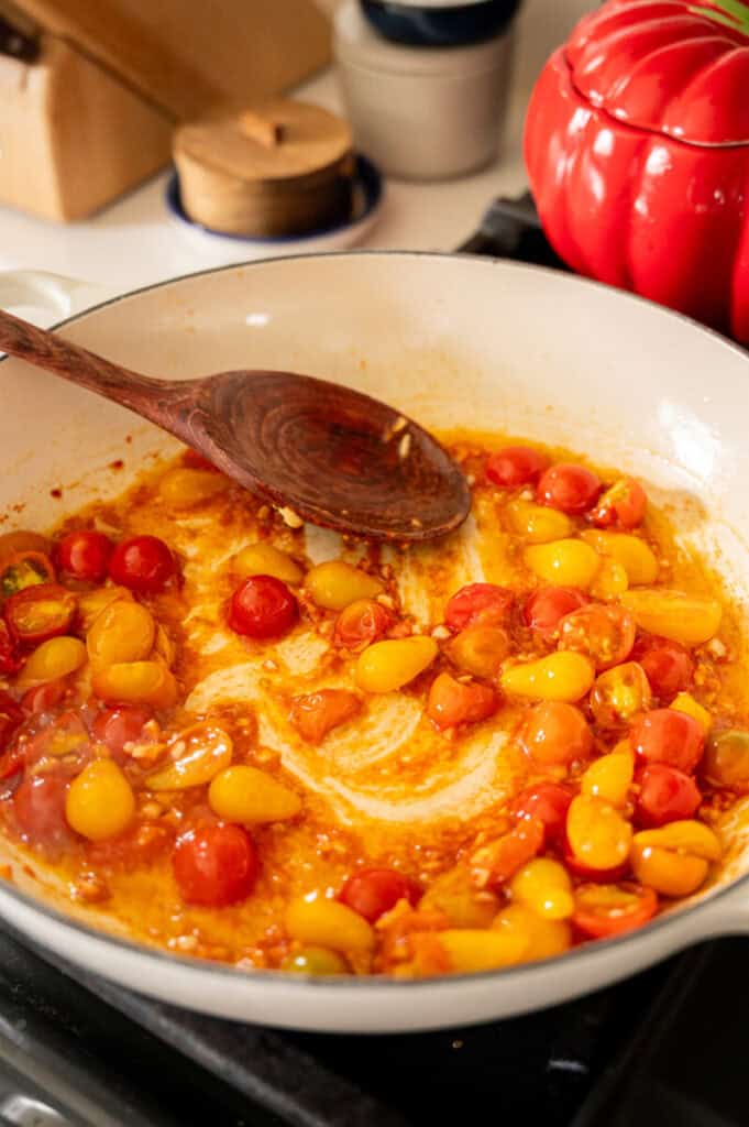 tomatoes cooking in a pan.