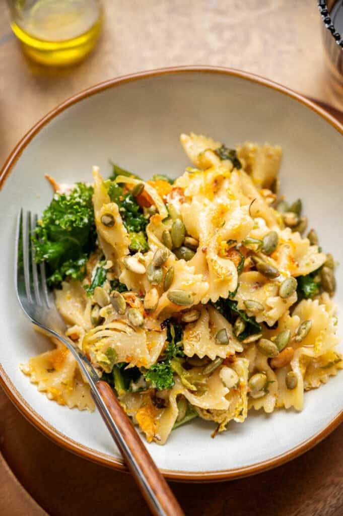 fall pasta salad with pepitas in a bowl.