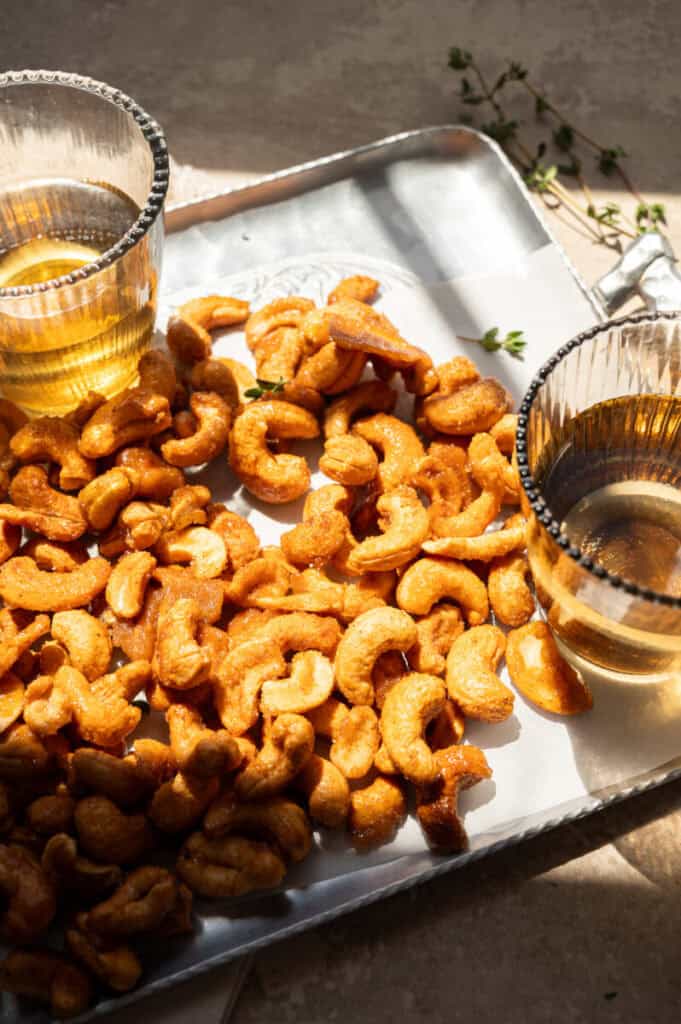 honey roasted cashews on a platter with hard light.