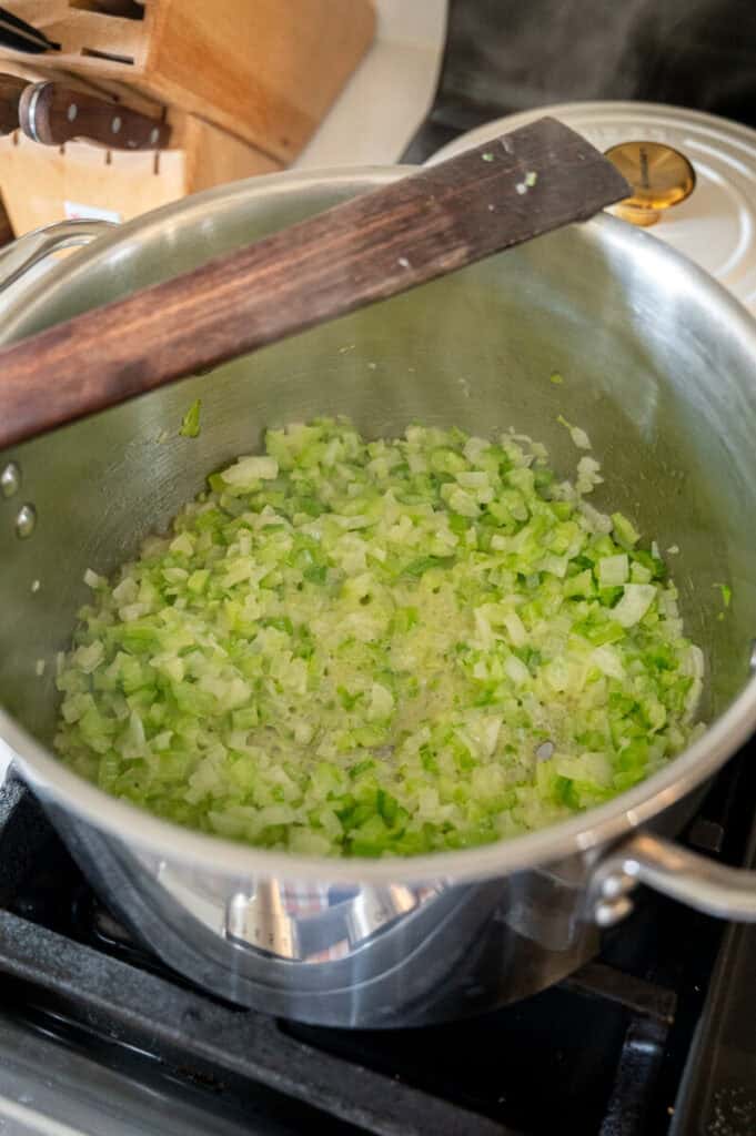cooked softened vegetables in a pot.