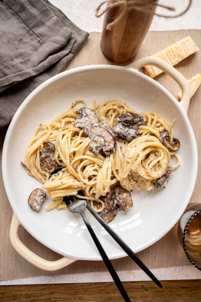 truffle mushroom pasta in a low bowl with a fork.