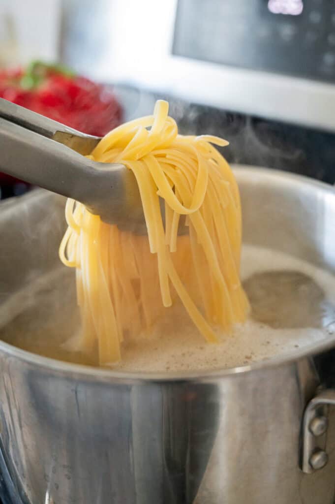 linguine cooking in a pot.