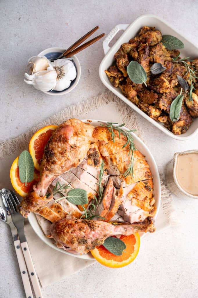 roast turkey on a plate with stuffing and gravy.